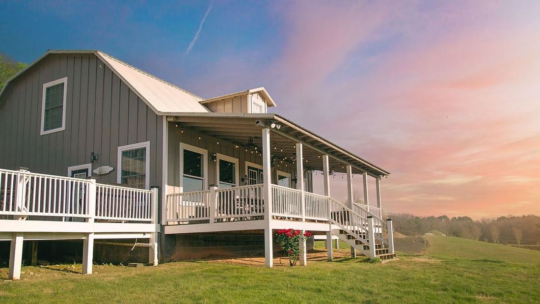 Watch the sunset from the string-lit porch of the Milkbarn, our converted grey barn farm stay at Cedar Pond Farms near the Smoky Mountains.