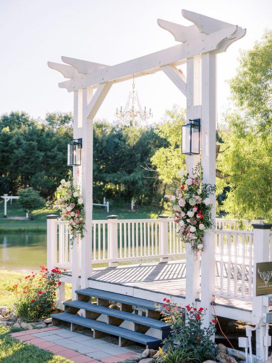 The Pond Side Dock dressed with flowers and lanterns for a ceremony